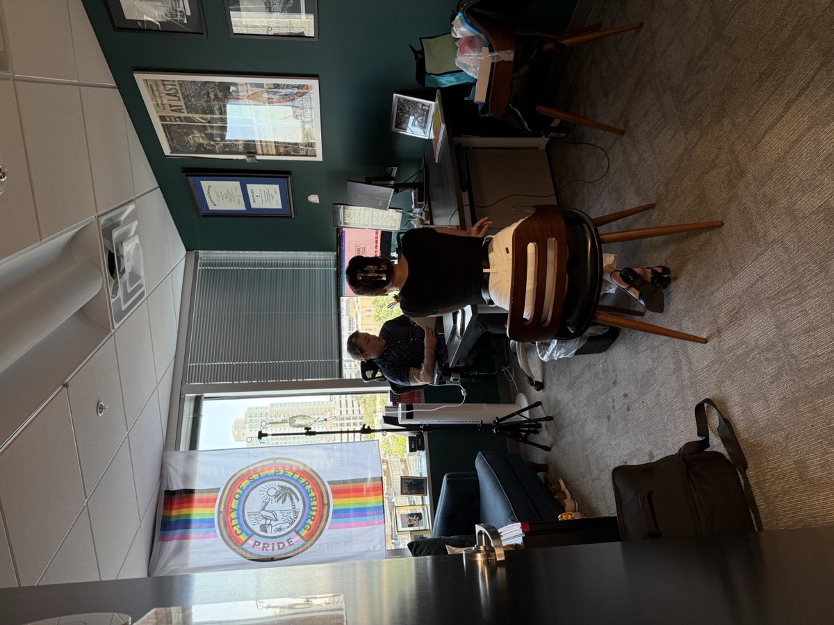 Busy professional receiving mobile IV therapy in her office before a travel day — Salty Fluids Immunity IV + energy support
